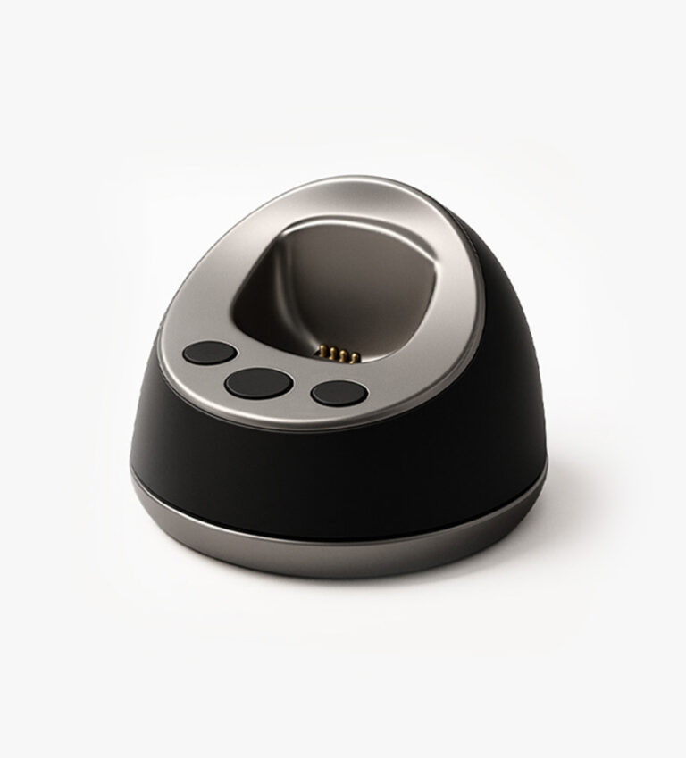 MiniFinder Pico charging base on white background, showing magnetic dock designed for easy cable-free charging.