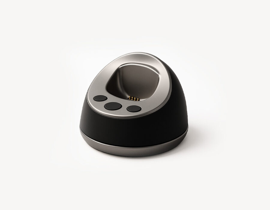 MiniFinder Pico charging base on white background, showing magnetic dock designed for easy cable-free charging.