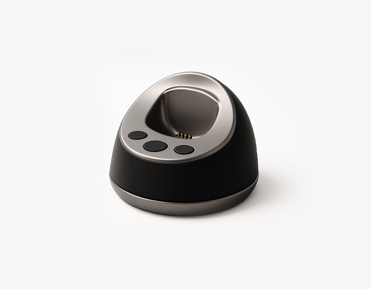 MiniFinder Pico charging base on white background, showing magnetic dock designed for easy cable-free charging.