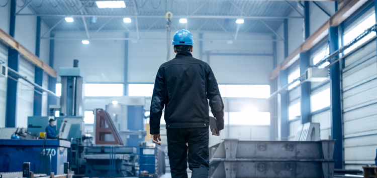 A man working alone using a personal safety alarm for increased security at work