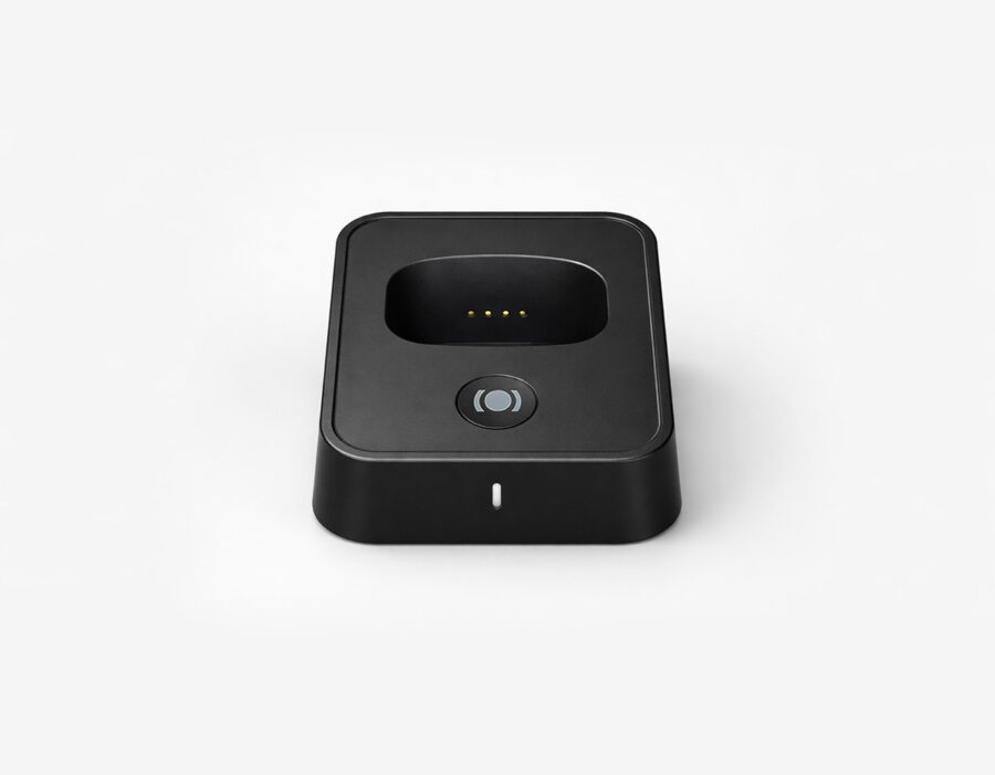 MiniFinder Nox personal alarm placed in its charging station, ready for daily use in professional environments.