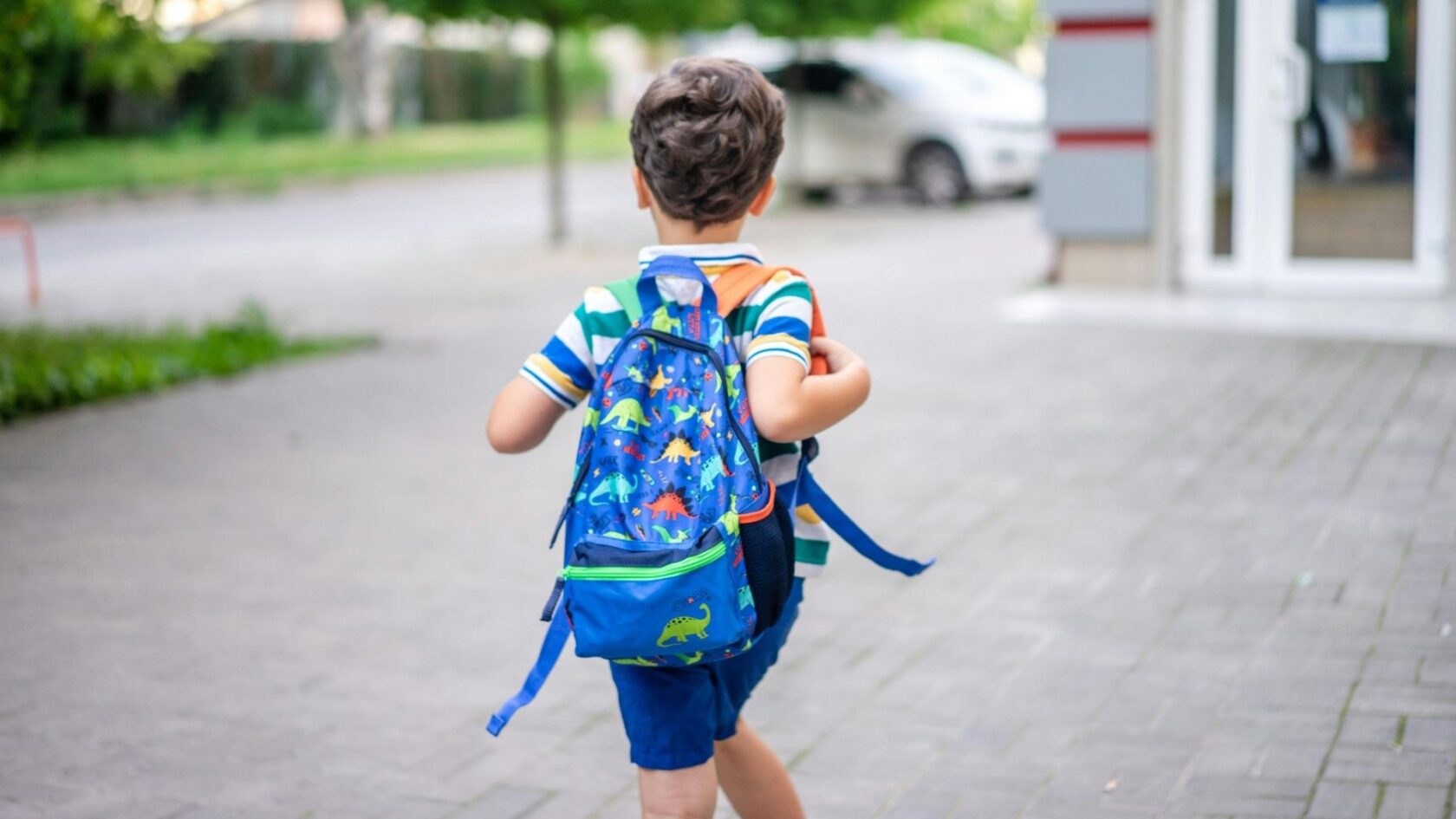 Child wearing a GPS watch while walking home from school with real-time location tracking for parents.